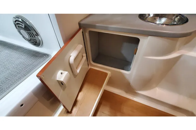 Slide: The Image of Interior storage compartment of 2013 Formula 310 Bowrider boat with sink and speaker. - 40