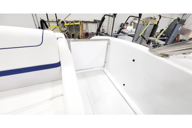Slide: The Image of 2013 Formula 310 Bowrider interior with white seating and blue accents. - 6