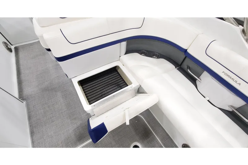 Slide: The Image of 2013 Formula 310 Bowrider interior with white seating and storage compartment open. - 8