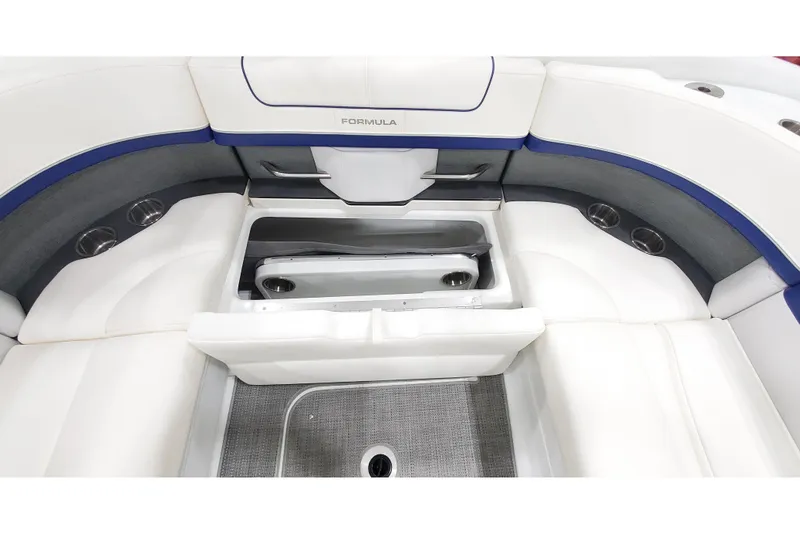 Slide: The Image of 2013 Formula 310 Bowrider interior with white seating and built-in storage compartment. - 9
