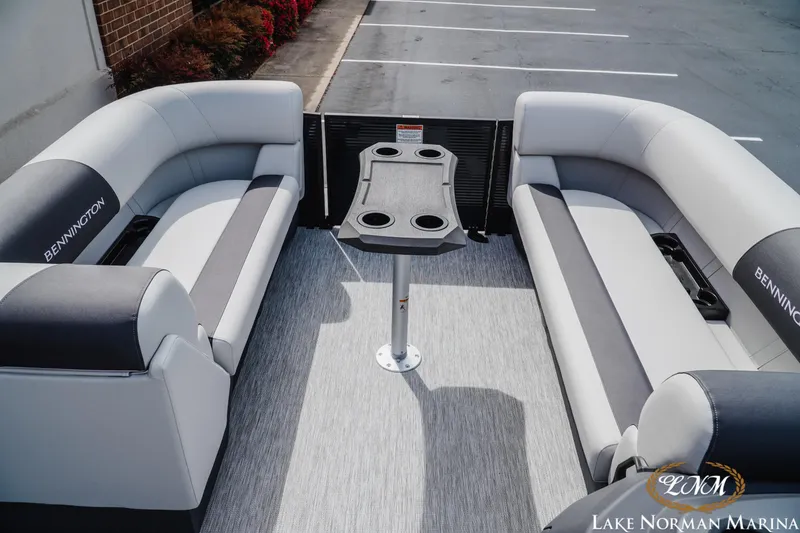 Slide: The Image of 2026 Bennington 22SSB pontoon boat interior with seating and table, at Lake Norman Marina. - 10