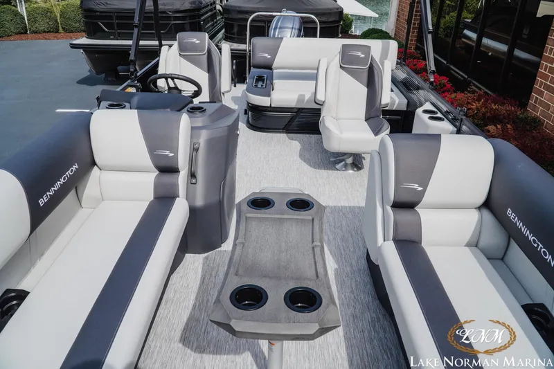 Slide: The Image of 2026 Bennington 22SSB pontoon boat interior with plush seating and cup holders at Lake Norman Marina. - 12