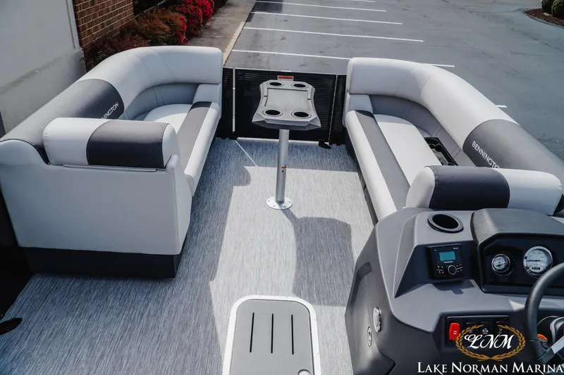 Slide: The Image of 2026 Bennington 22SSB pontoon boat interior with plush seating and modern dashboard. - 7