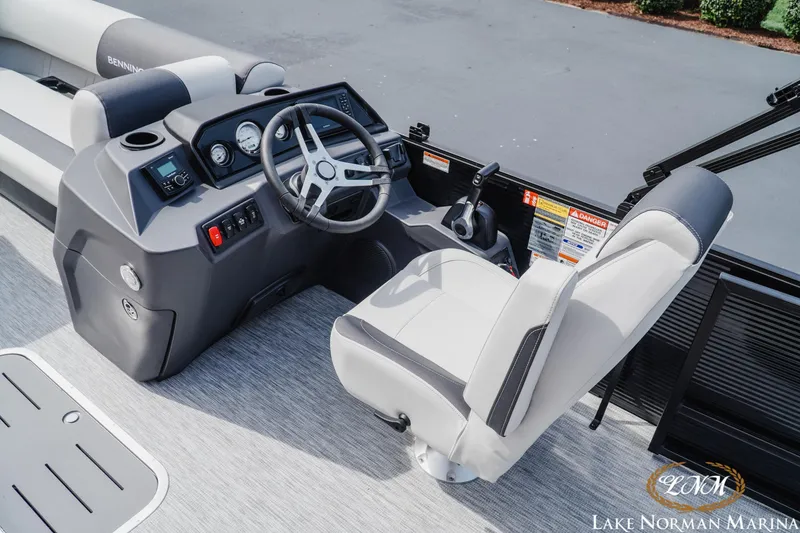 Slide: The Image of 2026 Bennington 22SSB boat cockpit with steering wheel and controls at Lake Norman Marina. - 8