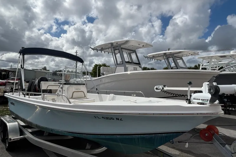 The Image of 2009 Sea Fox 195 Bay Fisher boat on trailer under cloudy sky. - 0