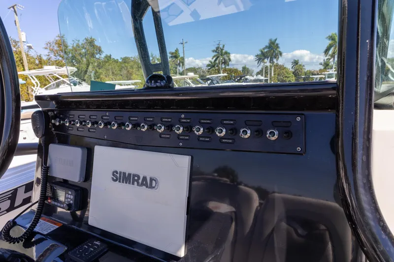 Slide: The Image of Control panel of a 2019 Wellcraft 262 Fisherman boat with Simrad electronics. - 13