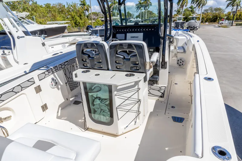 Slide: The Image of 2019 Wellcraft 262 Fisherman boat interior with seating and control panel, docked outdoors. - 15