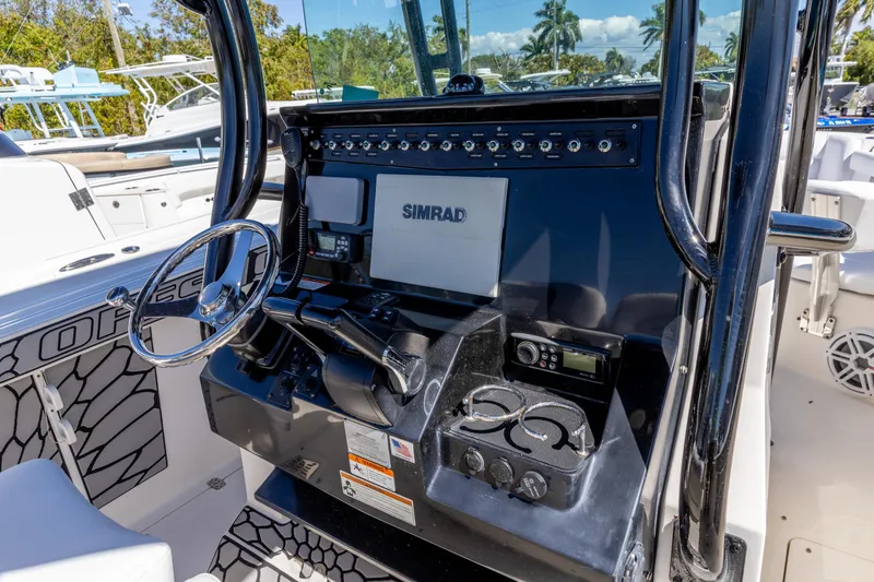 Slide: The Image of 2019 Wellcraft 262 Fisherman boat console with Simrad display and controls. - 3