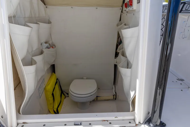 Slide: The Image of Interior of 2019 Wellcraft 262 Fisherman boat featuring a compact marine toilet. - 5