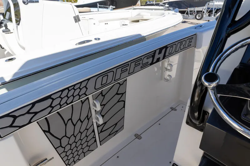 Slide: The Image of 2019 Wellcraft 262 Fisherman boat interior with "Offshore" branding and stylish design elements. - 8