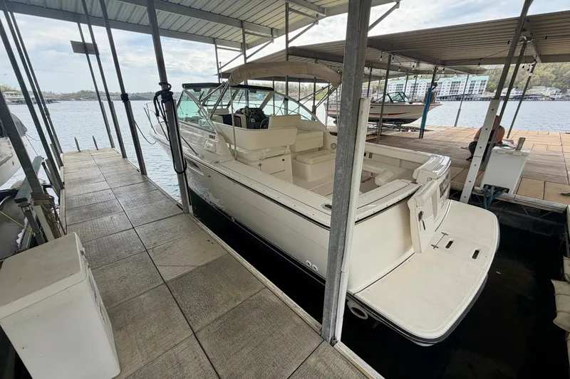 Slide: The Image of 2000 Tiara Yachts 2900 Coronet docked in a covered marina slip. - 11