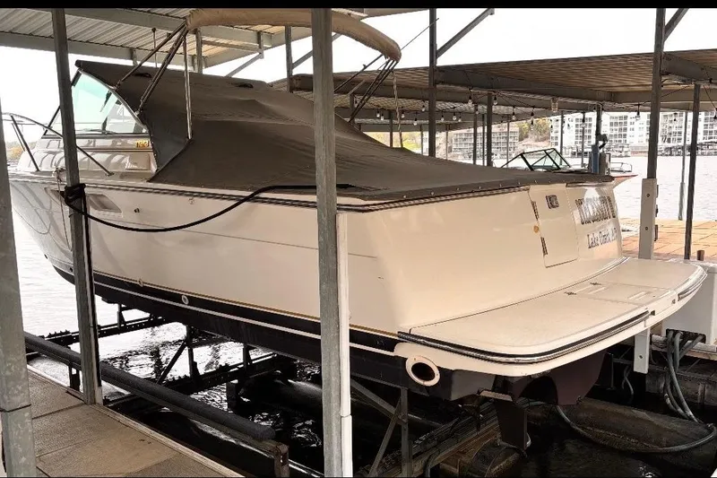 Slide: The Image of 2000 Tiara Yachts 2900 Coronet docked under a covered marina. - 13