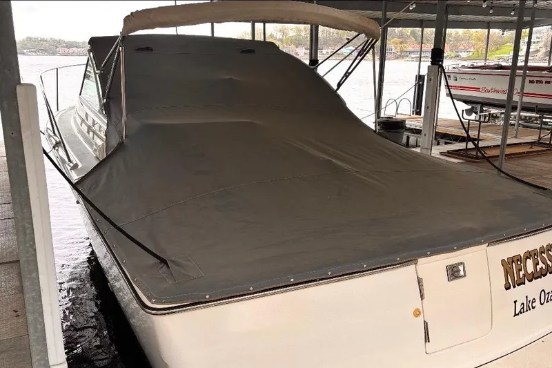 Slide: The Image of 2000 Tiara Yachts 2900 Coronet covered at dock, Lake Ozark backdrop. - 14