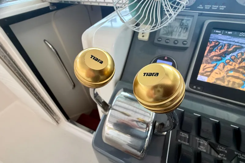 Slide: The Image of Control panel of a 2000 Tiara Yachts 2900 Coronet with gold throttle knobs. - 18
