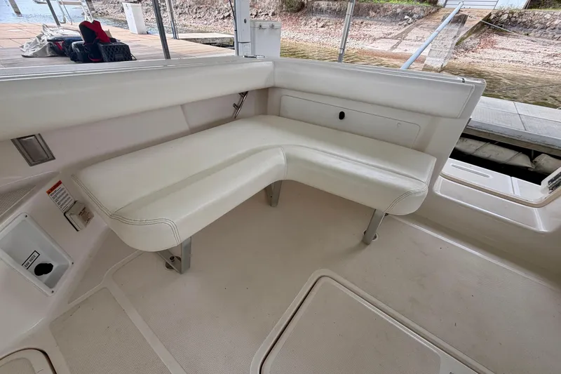 Slide: The Image of Interior seating of 2000 Tiara Yachts 2900 Coronet, featuring white cushioned bench. - 22