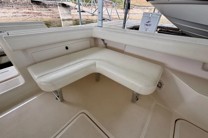 Slide: The Image of Interior seating of 2000 Tiara Yachts 2900 Coronet, featuring white cushioned L-shaped bench. - 23