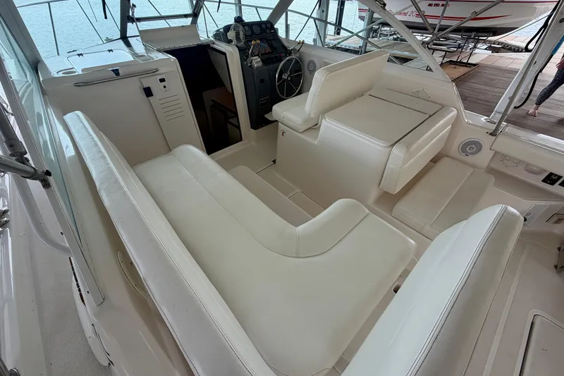 Slide: The Image of Interior of 2000 Tiara Yachts 2900 Coronet with white seating and helm. - 25