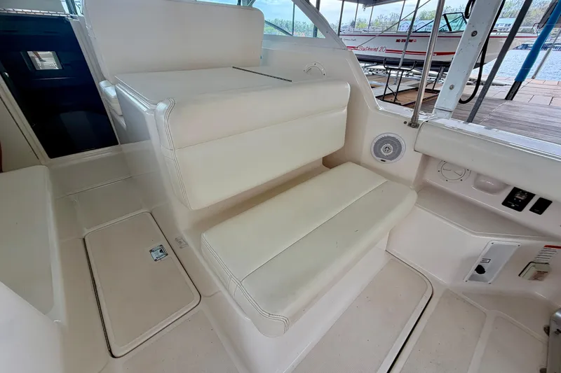 Slide: The Image of Interior seating of 2000 Tiara Yachts 2900 Coronet, featuring white cushioned seats. - 26