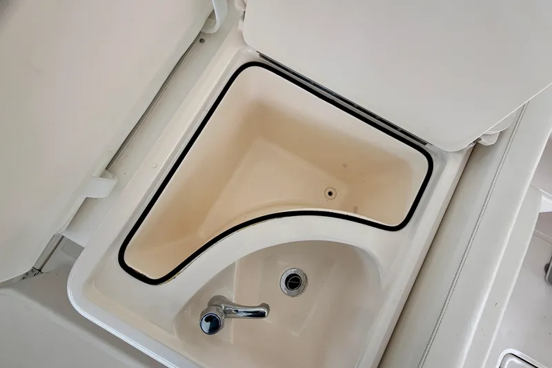 Slide: The Image of Sink and storage compartment on a 2000 Tiara Yachts 2900 Coronet boat. - 28