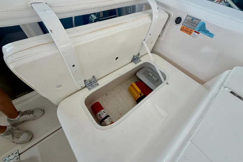 Slide: The Image of Storage compartment on a 2000 Tiara Yachts 2900 Coronet, containing safety equipment. - 30