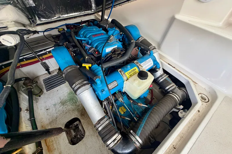 Slide: The Image of Engine compartment of a 2000 Tiara Yachts 2900 Coronet, featuring a blue marine engine. - 38