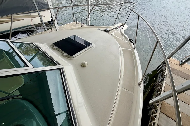 Slide: The Image of 2000 Tiara Yachts 2900 Coronet docked, showcasing sleek deck design and water view. - 7