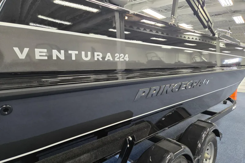 Slide: The Image of 2026 Princecraft Ventura 224 boat displayed indoors on a trailer. - 2
