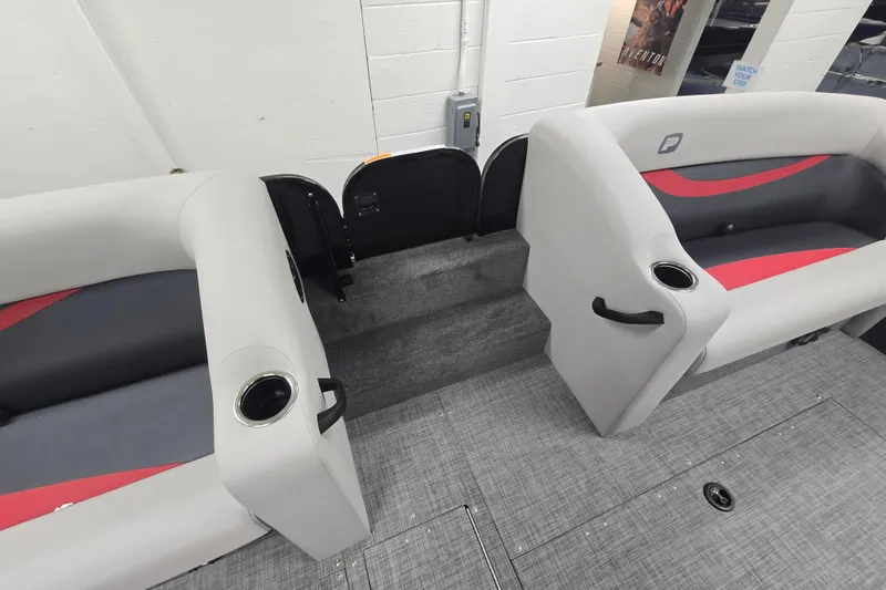 Slide: The Image of 2026 Princecraft Ventura 224 boat interior with gray and red seating, cup holders, and carpeted flooring. - 7