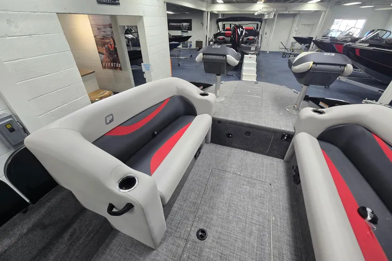Slide: The Image of 2026 Princecraft Ventura 224 boat interior with gray and red seating in showroom. - 8