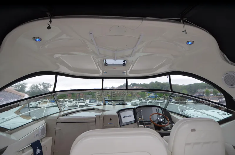 Slide: The Image of 2007 Sea Ray 38 Sundancer yacht docked by a serene river with lush greenery. - 13