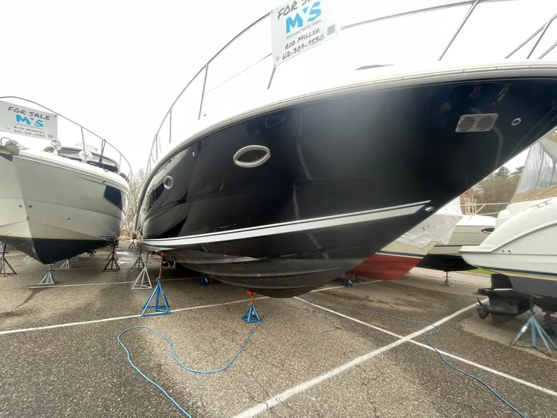 Slide: The Image of 2007 Sea Ray 38 Sundancer yacht docked, featuring sleek white deck and black cover. - 15