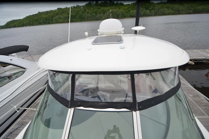 Slide: The Image of 2007 Sea Ray 38 Sundancer cabin interior with bed, porthole, and TV. - 17