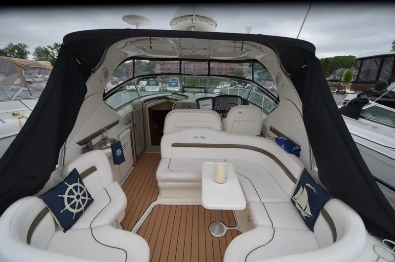 Slide: The Image of 2007 Sea Ray 38 Sundancer interior with white seating and nautical-themed decor. - 2
