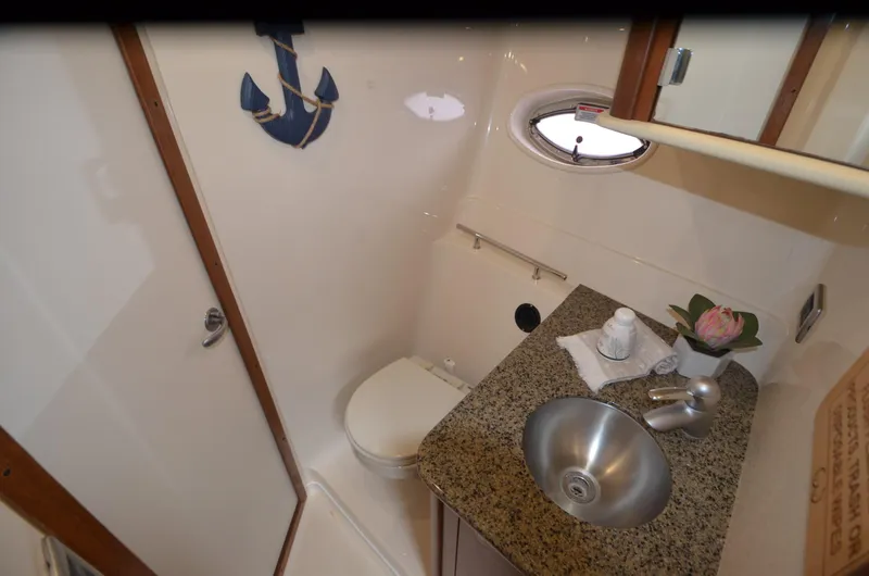Slide: The Image of Luxurious interior of 2007 Sea Ray 38 Sundancer with cream leather seating and nautical decor. - 27
