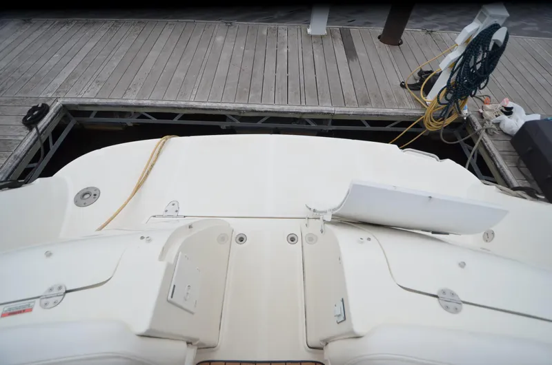 Slide: The Image of 2007 Sea Ray 38 Sundancer helm with wooden steering wheel and modern navigation controls. - 4