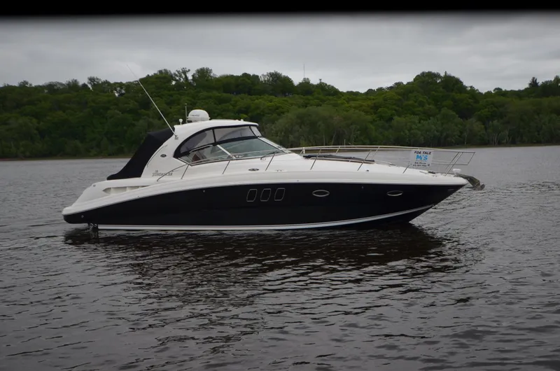 Slide: The Image of 2007 Sea Ray 38 Sundancer yacht docked at marina, featuring sleek design and luxurious amenities. - 40
