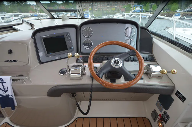 Slide: The Image of 2007 Sea Ray 38 Sundancer cockpit with helm, steering wheel, and navigation equipment. - 6
