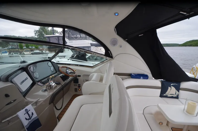 Slide: The Image of Luxurious 2007 Sea Ray 38 Sundancer yacht interior with white seating and nautical decor. - 9