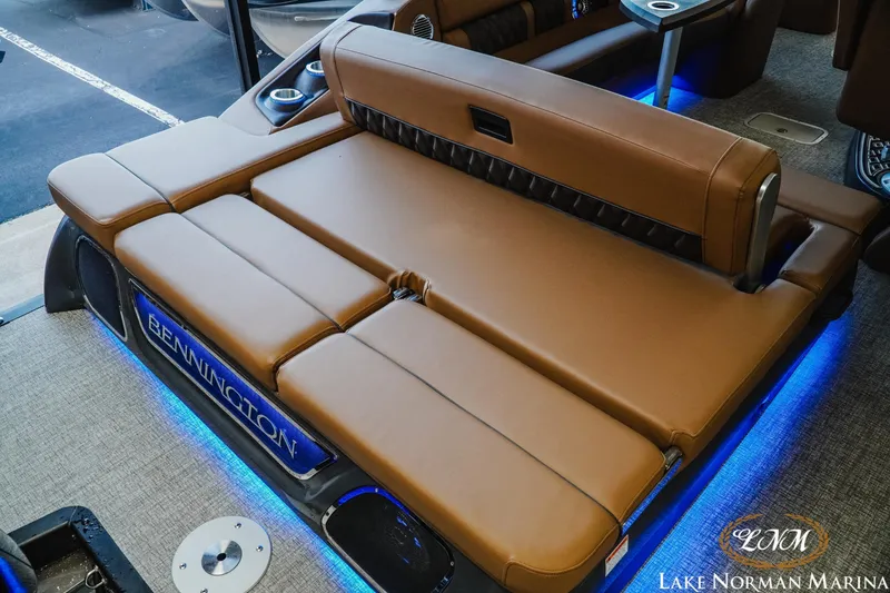 Slide: The Image of Luxurious seating on 2026 Bennington 25QSBA boat with ambient blue lighting. - 11