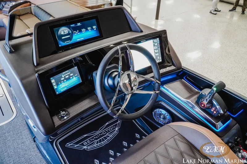 Slide: The Image of 2026 Bennington 25QSBA boat dashboard with advanced controls and digital displays at Lake Norman Marina. - 14