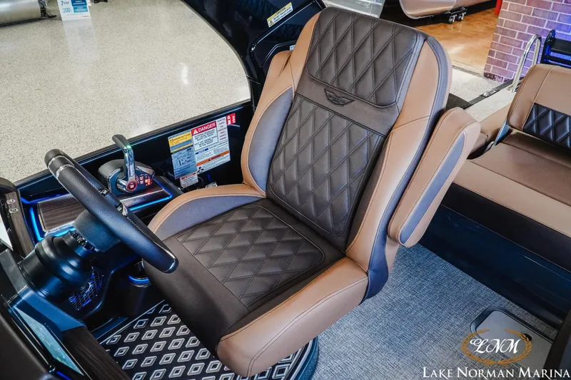 Slide: The Image of 2026 Bennington 25QSBA boat interior with luxurious diamond-stitched captain's chair at Lake Norman Marina. - 16