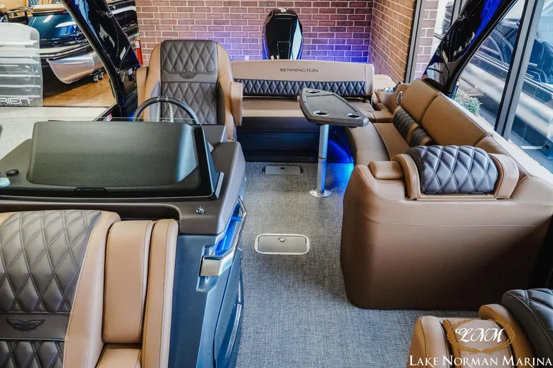 Slide: The Image of Luxurious interior of 2026 Bennington 25QSBA pontoon boat with plush seating and modern design. - 7