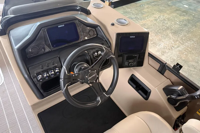 Slide: The Image of 2026 Bentley Pontoons 253 Elite Swingback Dual Capt EXT dashboard with steering wheel and controls. - 13