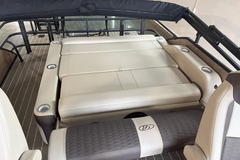 Slide: The Image of 2026 Bentley Pontoons 253 Elite Swingback Dual Capt EXT interior with luxurious seating and cup holders. - 19