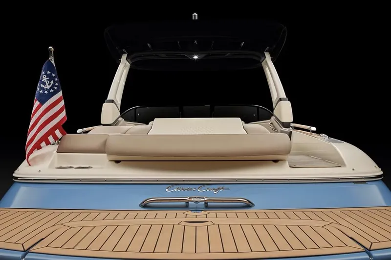 Slide: The Image of Manufacturer Provided Image: 2025 Chris-Craft Sportster 25 boat, rear view with American flag, teak deck. - 12