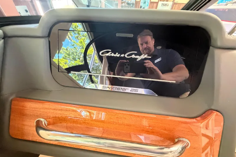 Slide: The Image of Interior view of a 2027 Chris-Craft Sportster 25 dashboard with reflective panel. - 35