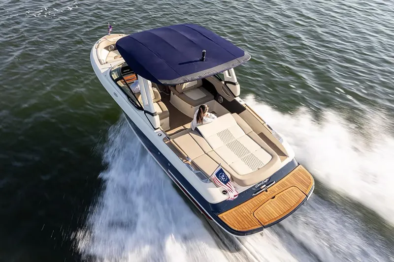 Slide: The Image of Manufacturer Provided Image: 2025 Chris-Craft Sportster 25 boat cruising on water. - 2