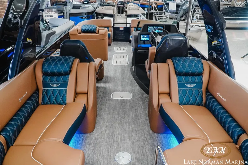 Slide: The Image of Luxurious interior of 2026 Bennington 25QXFBA boat with plush seating and modern dashboard. - 15