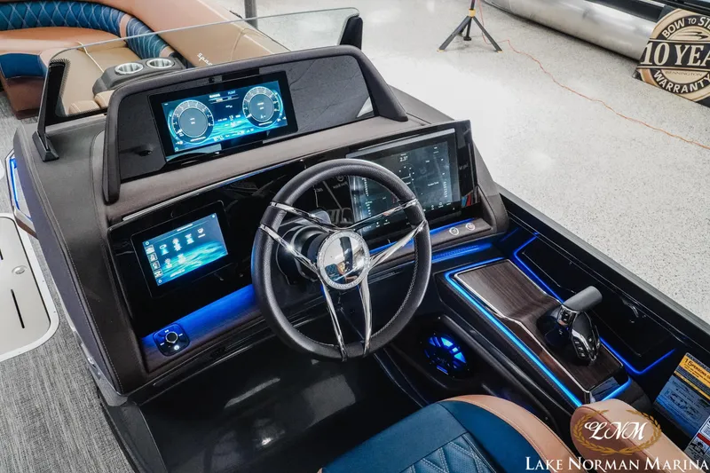 Slide: The Image of 2026 Bennington 25QXFBA boat dashboard with advanced digital displays at Lake Norman Marina. - 18