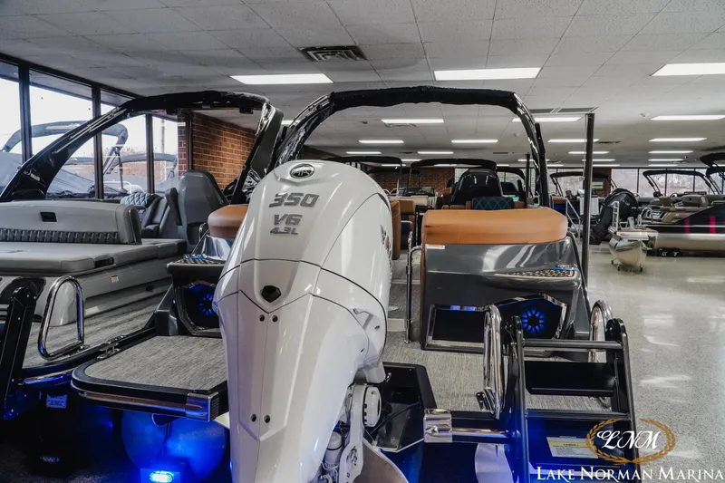 Slide: The Image of 2026 Bennington 25QXFBA boat with powerful V6 engine displayed indoors. - 4